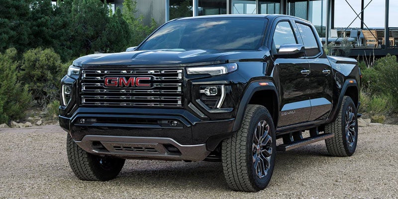 Black 2026 GMC Canyon Denali parked outdoors showcasing front exterior styling